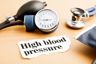 Stethoscope, blood pressure gauge and hypertension headline