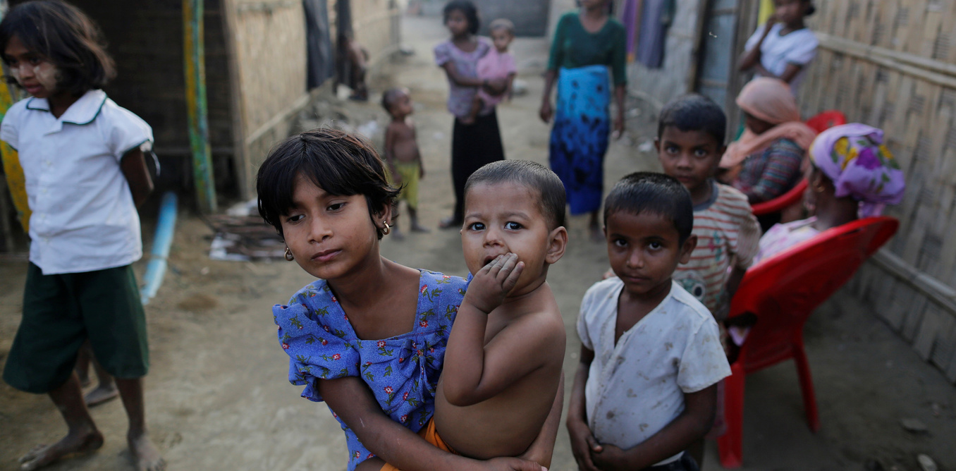 A Rohingya refugee girl carries a baby inside a refugee camp in Sitwe, in the state of Rakhine, Myanmar March 4, 2017. Picture taken March 4, 2017.  REUTERS/Soe Zeya Tun - RTX313NW